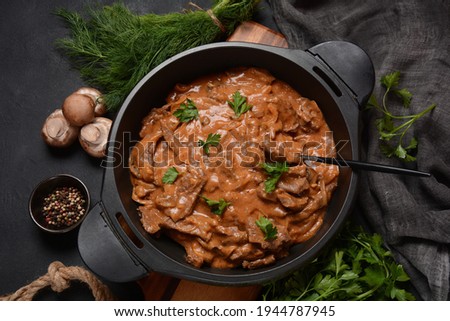 Beef Stroganoff with cremini and champignons on a frying pan.