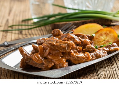 Beef Stroganoff,  Original Recipe Of Russian Dish. Thin Strips Of Beef  Cooked In Sour Cream And Tomato Paste,  Served With Crisp Potato