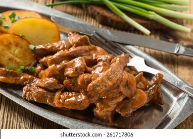 Beef Stroganoff,  Original Recipe Of Russian Dish. Thin Strips Of Beef  Cooked In Sour Cream And Tomato Paste,  Served With Crisp Potato