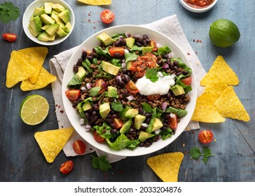 Beef Taco salad with romaine lettuce, avocado, tomato salsa, black bean and tortilla chips. Mexican healthy food