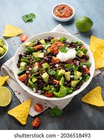 Beef Taco Salad With Romaine Lettuce, Avocado, Tomato Salsa, Black Bean And Tortilla Chips. Mexican Healthy Food