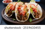 Beef Tacos: Soft or crunchy taco shells filled with seasoned ground beef, shredded lettuce, cheese, and salsa, topped with a dollop of sour cream for a classic taco experience.