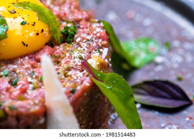 Beef tartare with an egg, basil and cheese