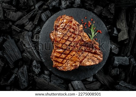 Beef T-bone steaks on BBQ grill coal. porterhouse steak or T Bone Steak. Restaurant menu, cookbook recipe. place for text, top view.