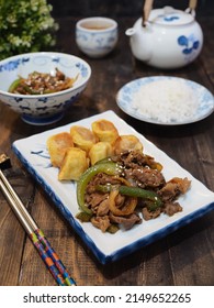 Beef Teriyaki And Egg Roll On White Plate With Chopstik And Blurry Background. Dark Photography