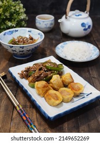 Beef Teriyaki And Egg Roll On White Plate With Chopstik And Blurry Background. Dark Photography