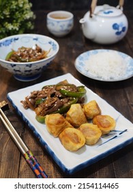 Beef Teriyaki And Egg Roll On White Plate With Chopstik And Blurry Background. Dark Photography