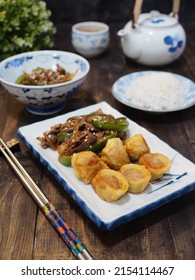 Beef Teriyaki And Egg Roll On White Plate With Chopstik And Blurry Background. Dark Photography