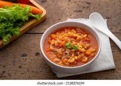 Beef And Tomato Macaroni Soup In White Bowl On Wood Table