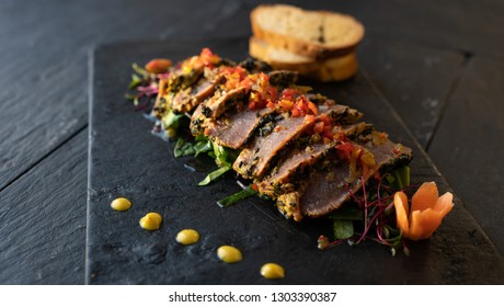 beef with vegetables, sauce and bread. mexican dish arrachera. black background