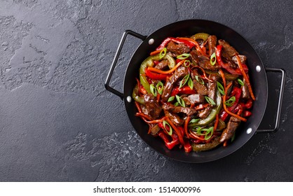 Beef And Vegetables Stir Fry In A Pan. Dark Background. Copy Space. Top View.