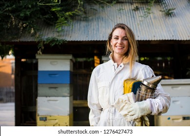 Beekeeper in front of her bee hives