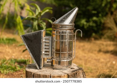 Beekeeping supplies, Bee Hive Smoker on the beehives. The process of extracting honey from the hive. Equipment for beekeepers with smoke for removal bees from wax. - Powered by Shutterstock