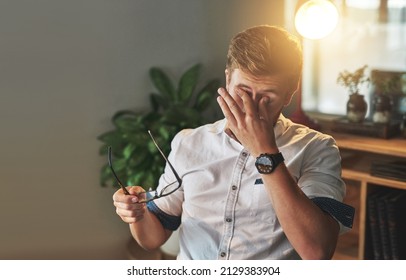 Its Been A Long Day.... Shot Of A Young Designer Looking Exhausted On His Night Shift.