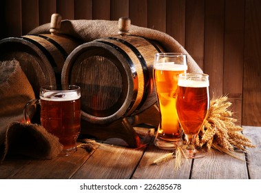 Beer Barrel With Beer Glasses On Table On Wooden Background