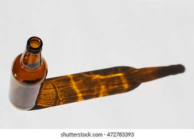 A Beer Bottle Casts A Shadow