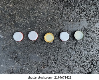 Beer Bottle Crown Seals Caps On Concrete Street Background Texture 