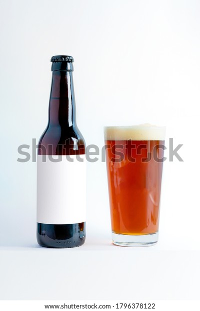 Beer Bottle Mock-Up with glass of altbier and\
foam. Blank Label on white\
background