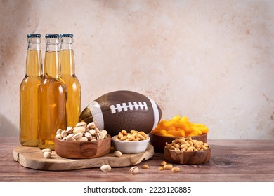 Beer In Bottle And Snack On Wooden Table With Rugby Ball, Game Night Food