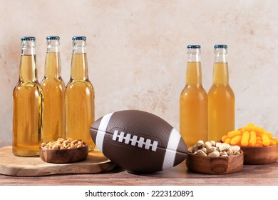 Beer In Bottle And Snack On Wooden Table With Rugby Ball, Game Night Food