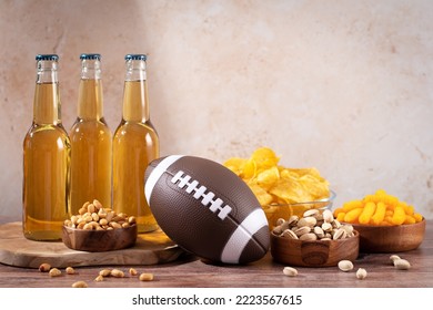 Beer In Bottle And Snack On Wooden Table With Rugby Ball, Game Night Food