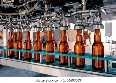 Beer bottles filling on the conveyor belt in the brewery factory - Powered by Shutterstock
