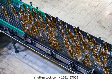 Beer Bottles Moving On Conveyor Belt, Top View, Close Up.