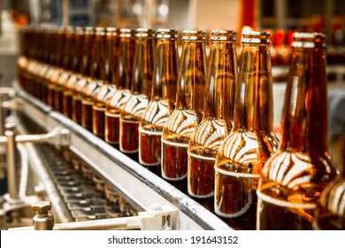 Beer bottles on the conveyor belt - Powered by Shutterstock