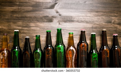 Beer Bottles On A Wooden Table . Top View