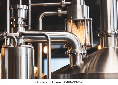 Beer brewing . Commercial brewing equipment close up shot. Industrial beer brewing stainless pipe - Shutterstock ID 2288633809