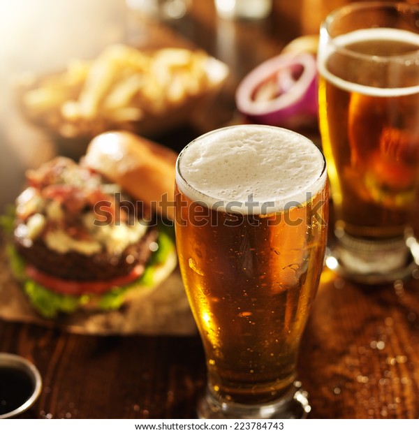 beer and burgers on wooden\
table