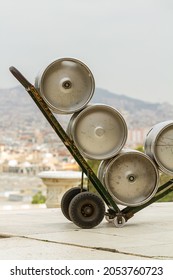 Beer Cans Stacked In A Metal Wheelbarrow.