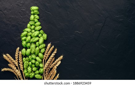 Beer Concept. Natural Ingredients Of Brewery Process- Hops Cones  And Wheat Ears. Pattern In Form Of Shape Of Beer Bottle. Oktoberfest Idea Board With Copy Space.