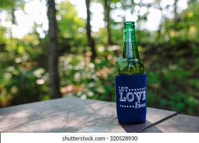 Beer In A Cooling Sleeve With Clover