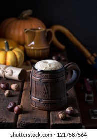 Beer In The Earthen Brown Cup On A Wooden Table Witj Pumpkins And Nuts, Warm Fairytale Atmosphere As If It Was Rubeus Hagrid`s Hut