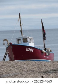 Beer England - September 26 2014: Old Red And Blue Fishing Trawler On The Beach