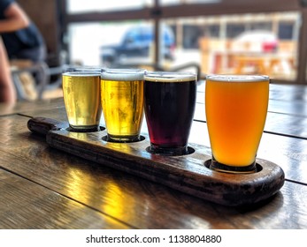 Beer Flight On Polished Wood Table At Brewery In Indianapolis, Indiana