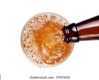 Beer flow in a glass from a brown bottle, top view