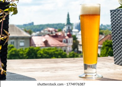 Beer in a glass against the background of a beautiful city