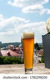 Beer in a glass against the background of a beautiful city