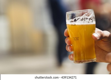 Beer In A Glass In His Hand, Illuminated By Sunlight