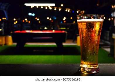 Beer In Glass On Pool Table Bar Bokeh Background In Night