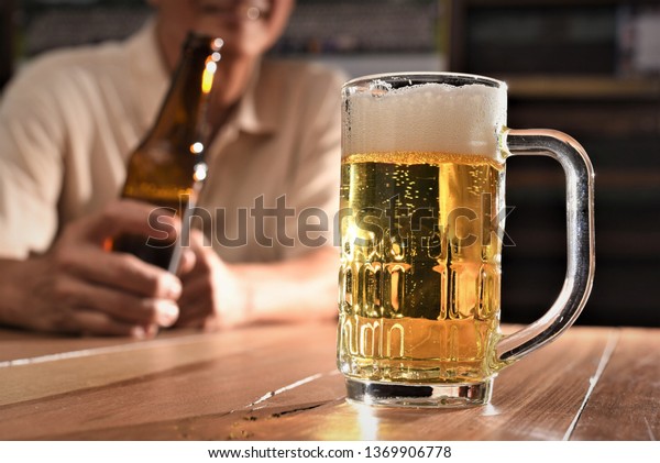 beer glass on wood table in pub