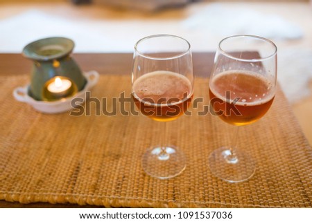 Beer glasses with aroma lamp romantic time at fireplace