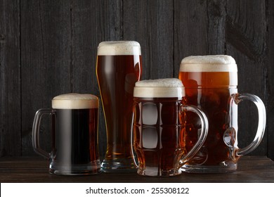 Beer Glasses With Lager, Dark Lager, Ale, Stout Beer On Table, Dark Wooden Background