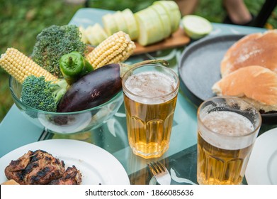 Beer, Kebab, Vegetables, Grill, Kebab Spread Out On The Picnic Table. A Warm Summer Day And A Trip To Nature. Photo With No People