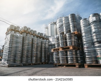 Beer kegs. Many metal barrels or containers for brewery in pallets stacked outdoors