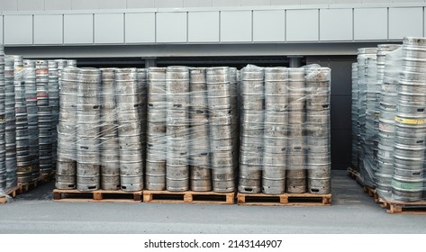 Beer kegs. Many metal barrels or containers for brewery in pallets stacked outdoors
