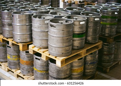 Beer Kegs. Many Metal Beer Keg Stand In Rows In A Warehouse