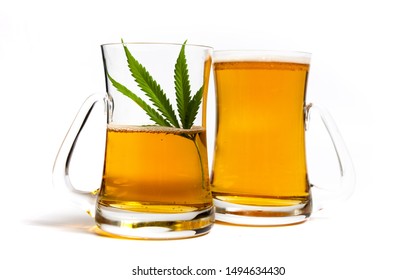 Beer with marijuana cannabis plant in a glass on white